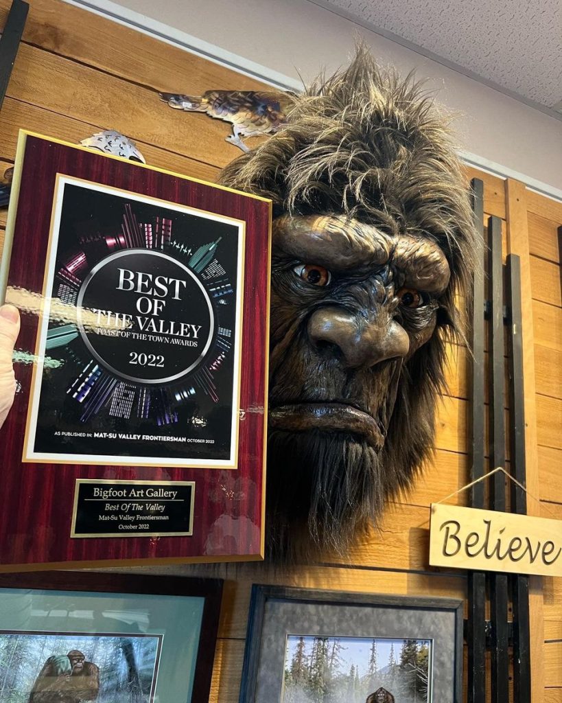 Image of the award plaque placed next to a Bigfoot bust.