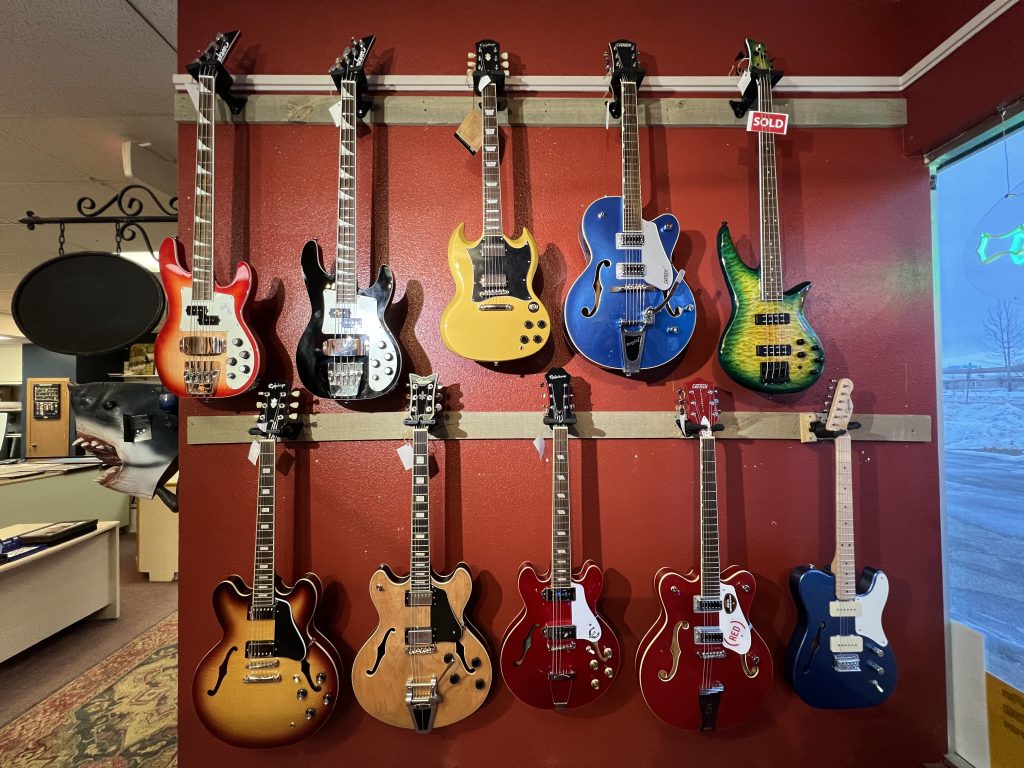Wide angle photo of guitars you can purchase at the gallery.