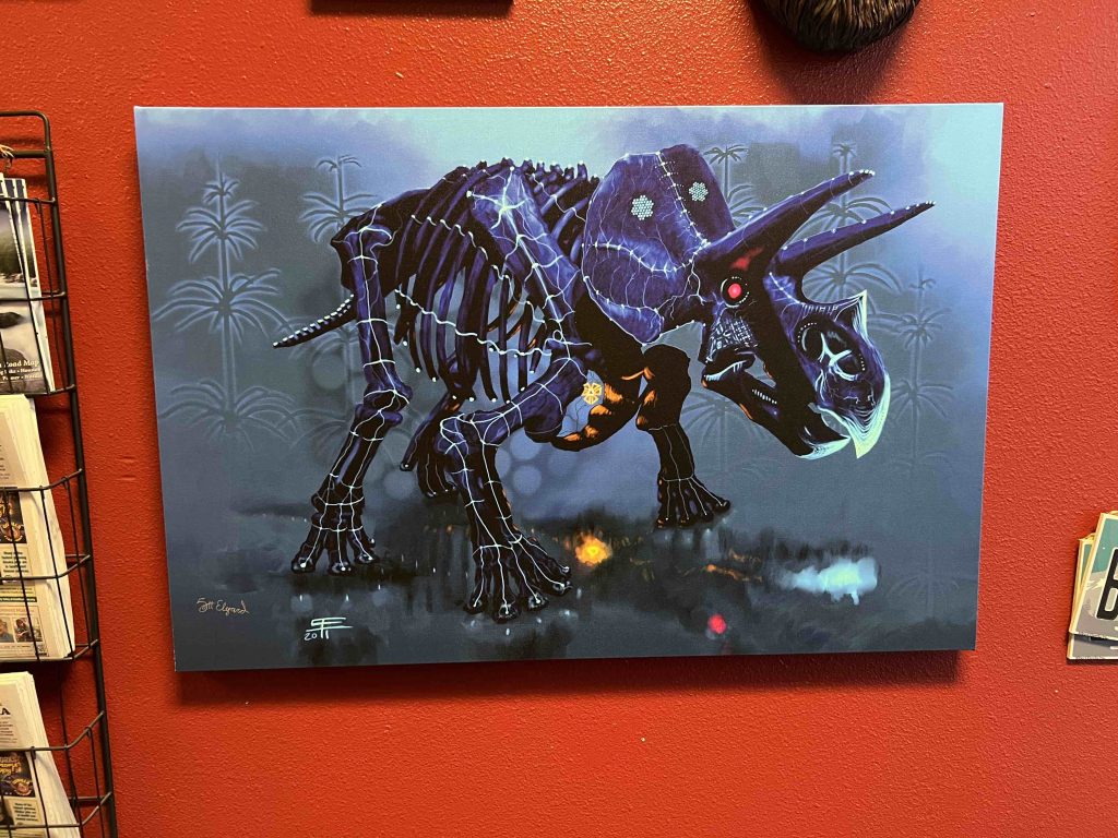 Colorful canvas painting of a dinosaur.